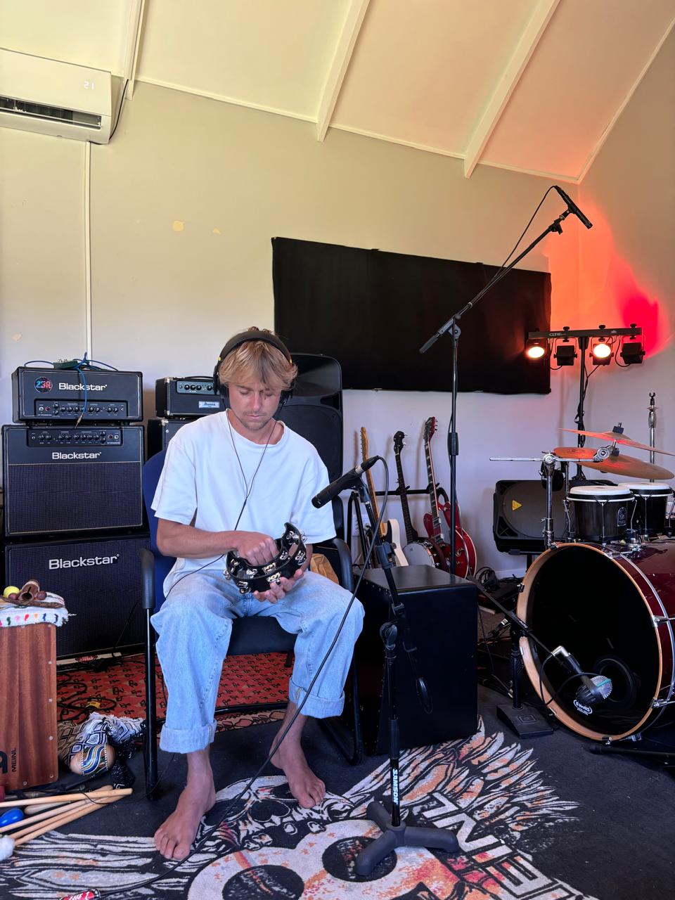Milo in the studio holding a tambourine