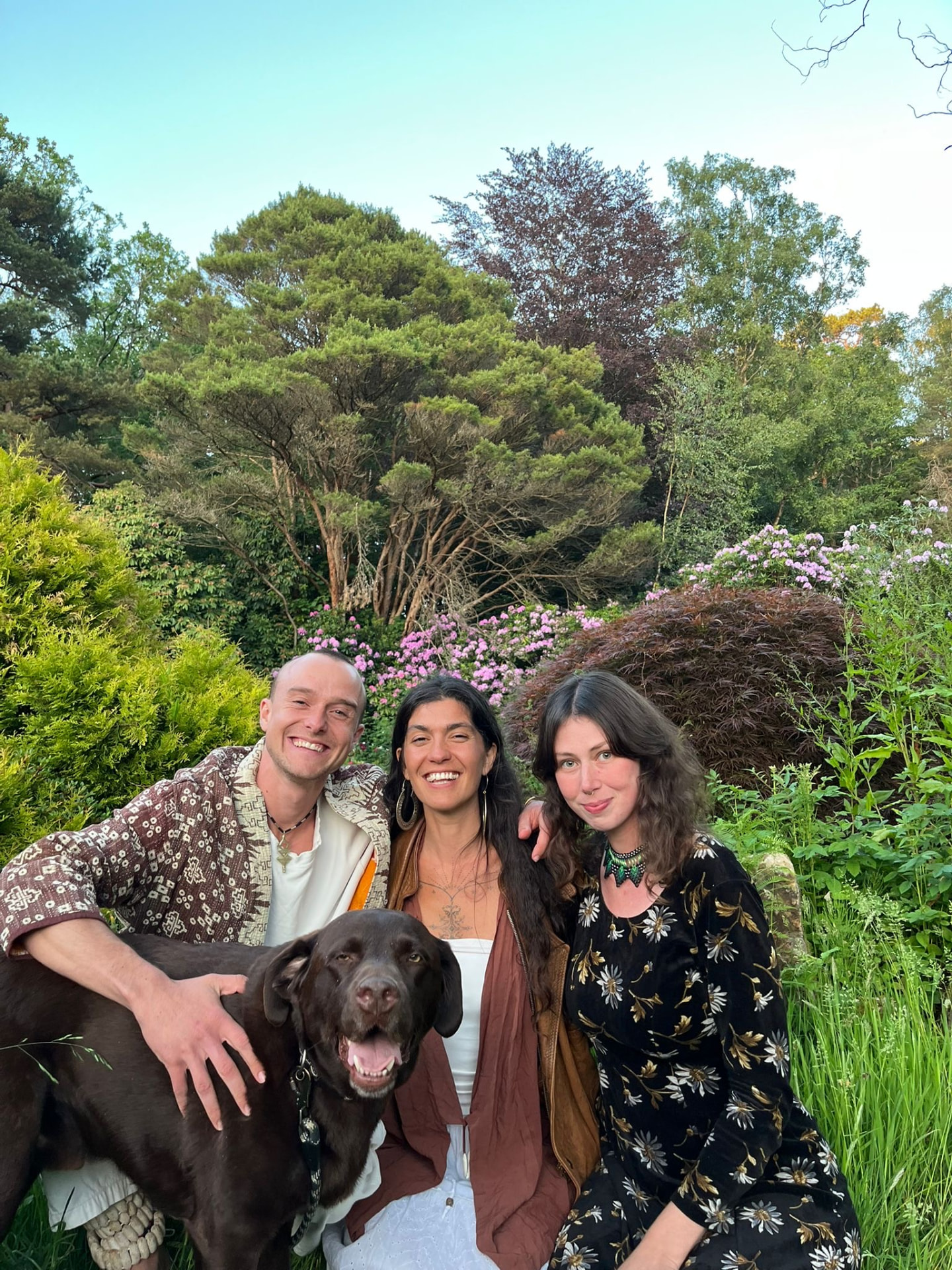 Genevieve and Milo with a friend and a dog in a garden